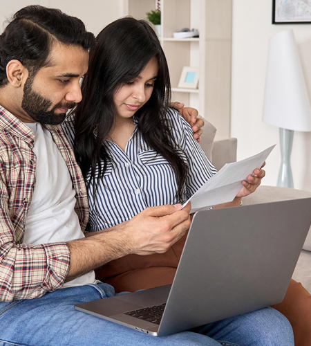 Couple On Laptop Looking At Form