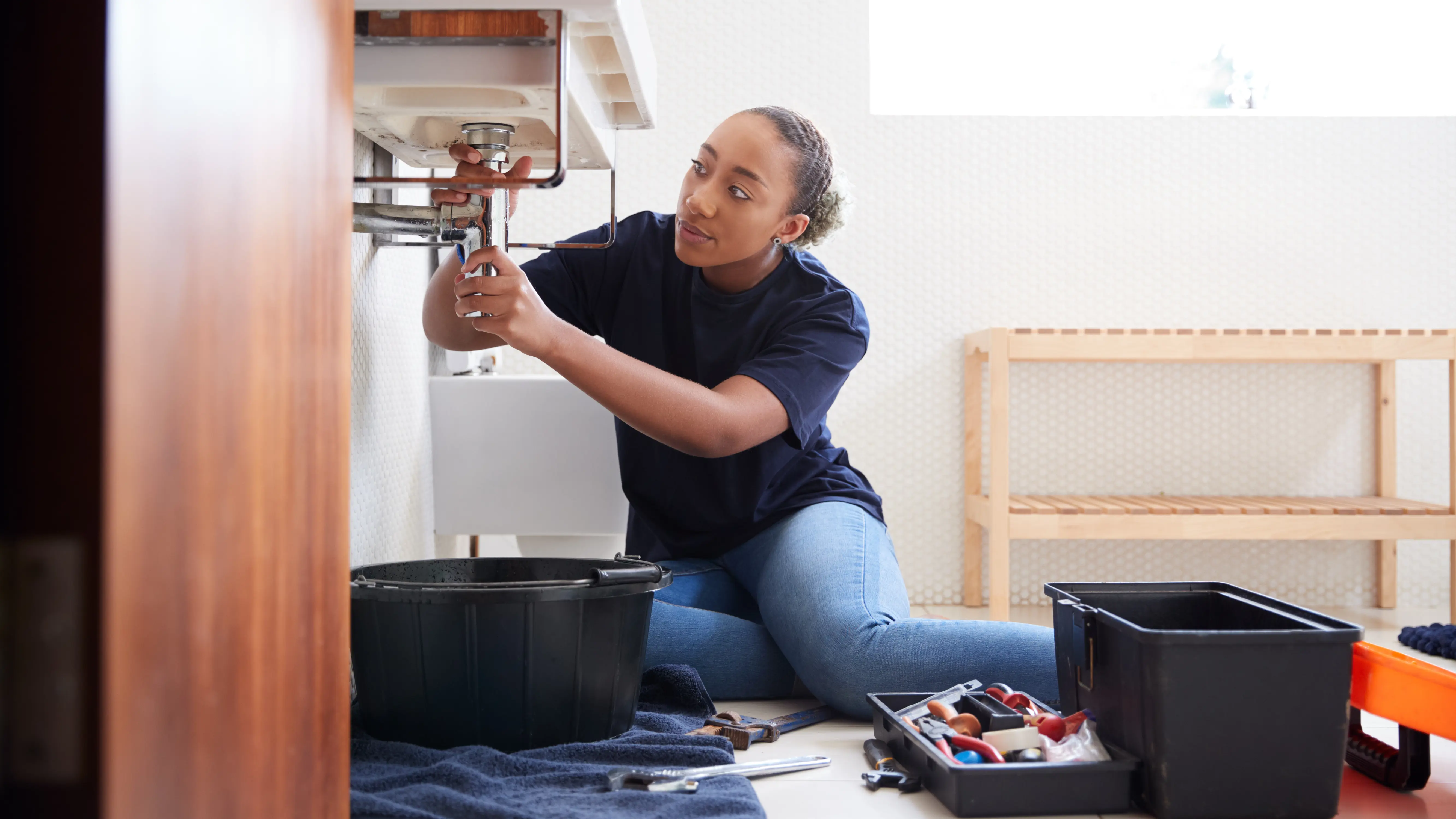 Woman Repairing Sink