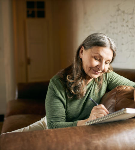 Woman Writing In A Book