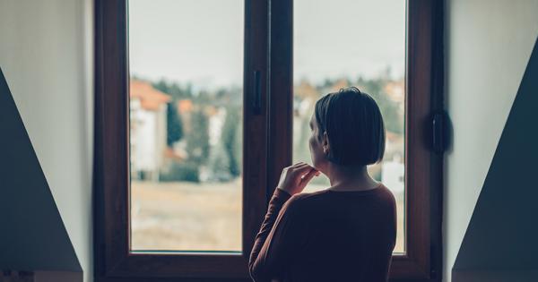 Woman At Home Stairing Out Of The Window