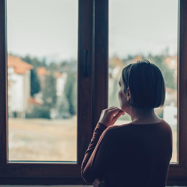 Woman At Home Stairing Out Of The Window