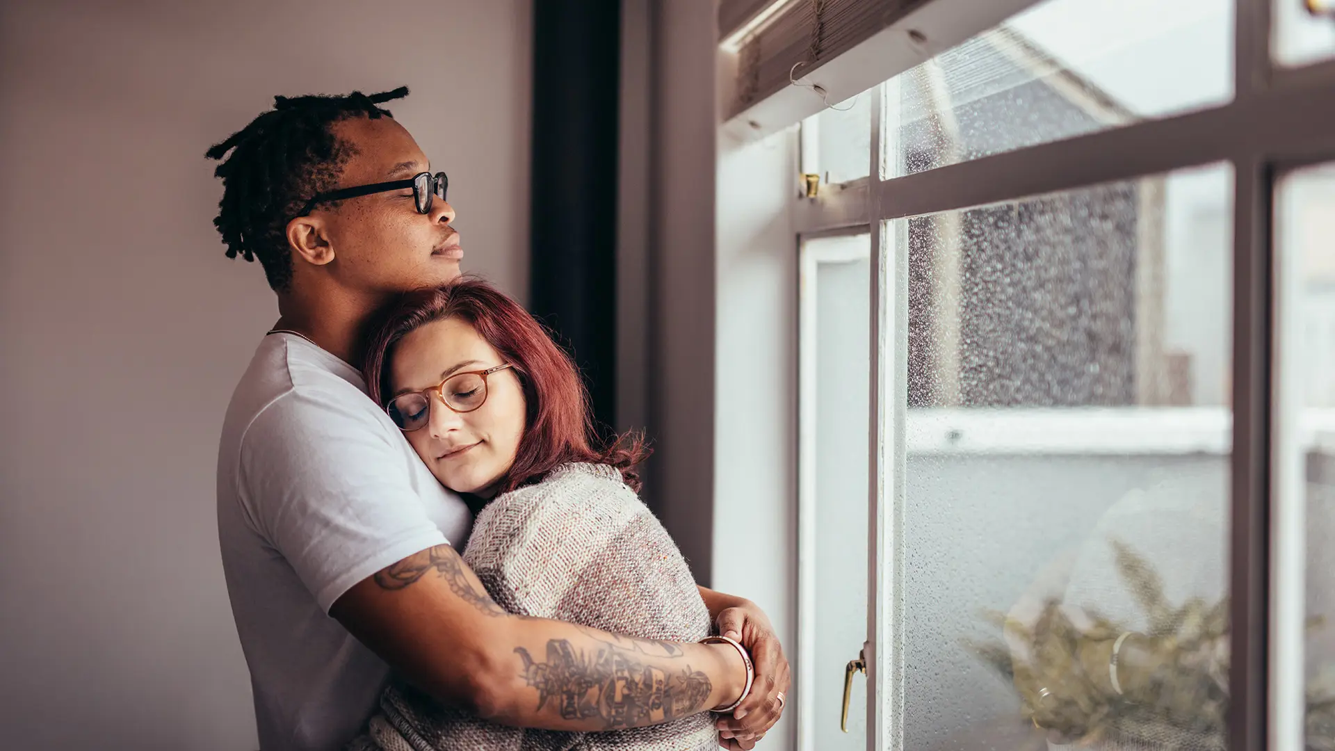 Young Couple Hugging Near Window