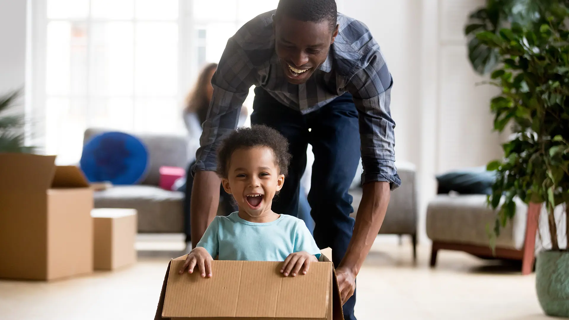 Family Moving In Young Boy In Box