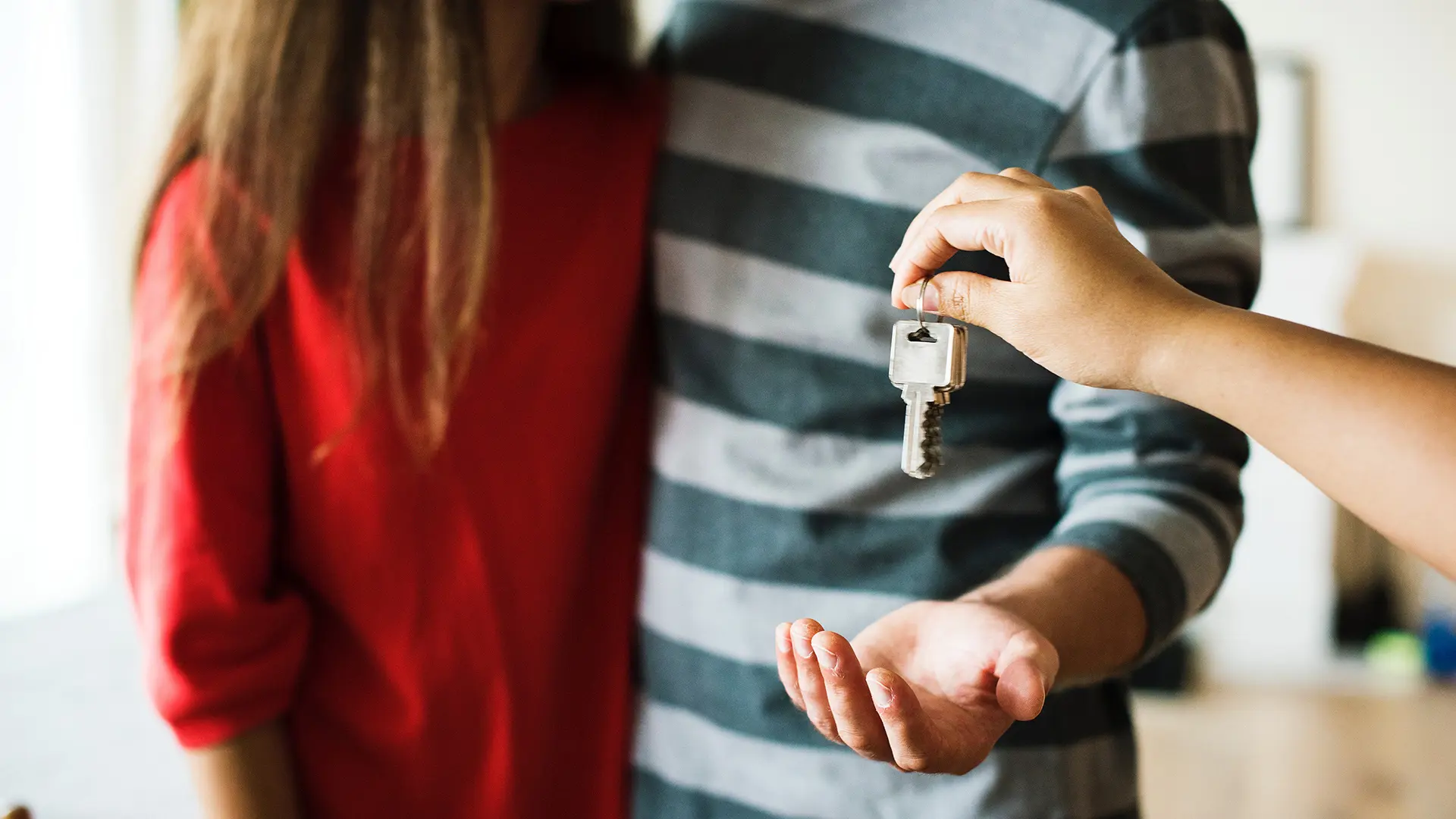 Couple Receiving Keys To Their New Home