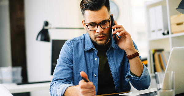 Young Man Speaking To Someone On The Phone Looking Concerned