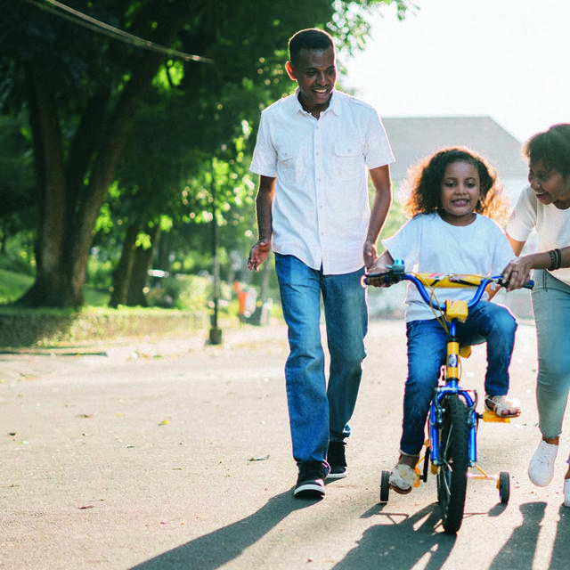 Parents With Child On Bike