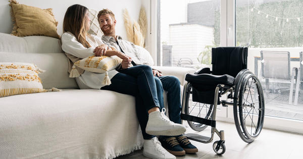 Couple At Home With Wheelchair