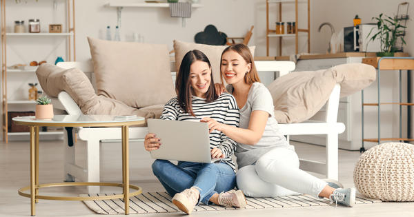 Young Couple Laughing On The Floor In Their Home