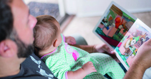 Father Reading Book To Child