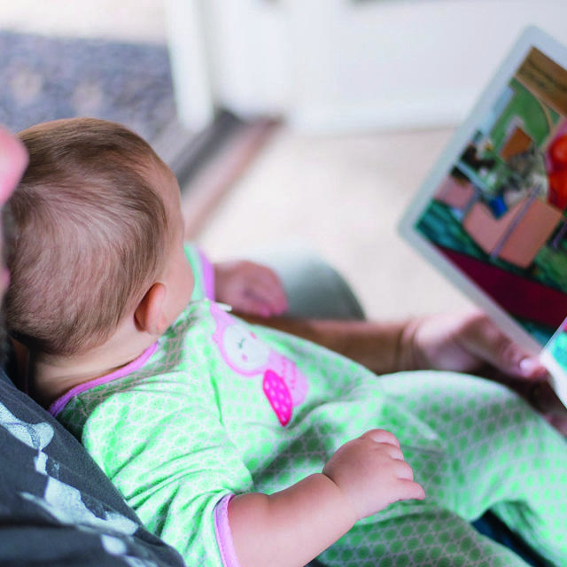 Father Reading Book To Child