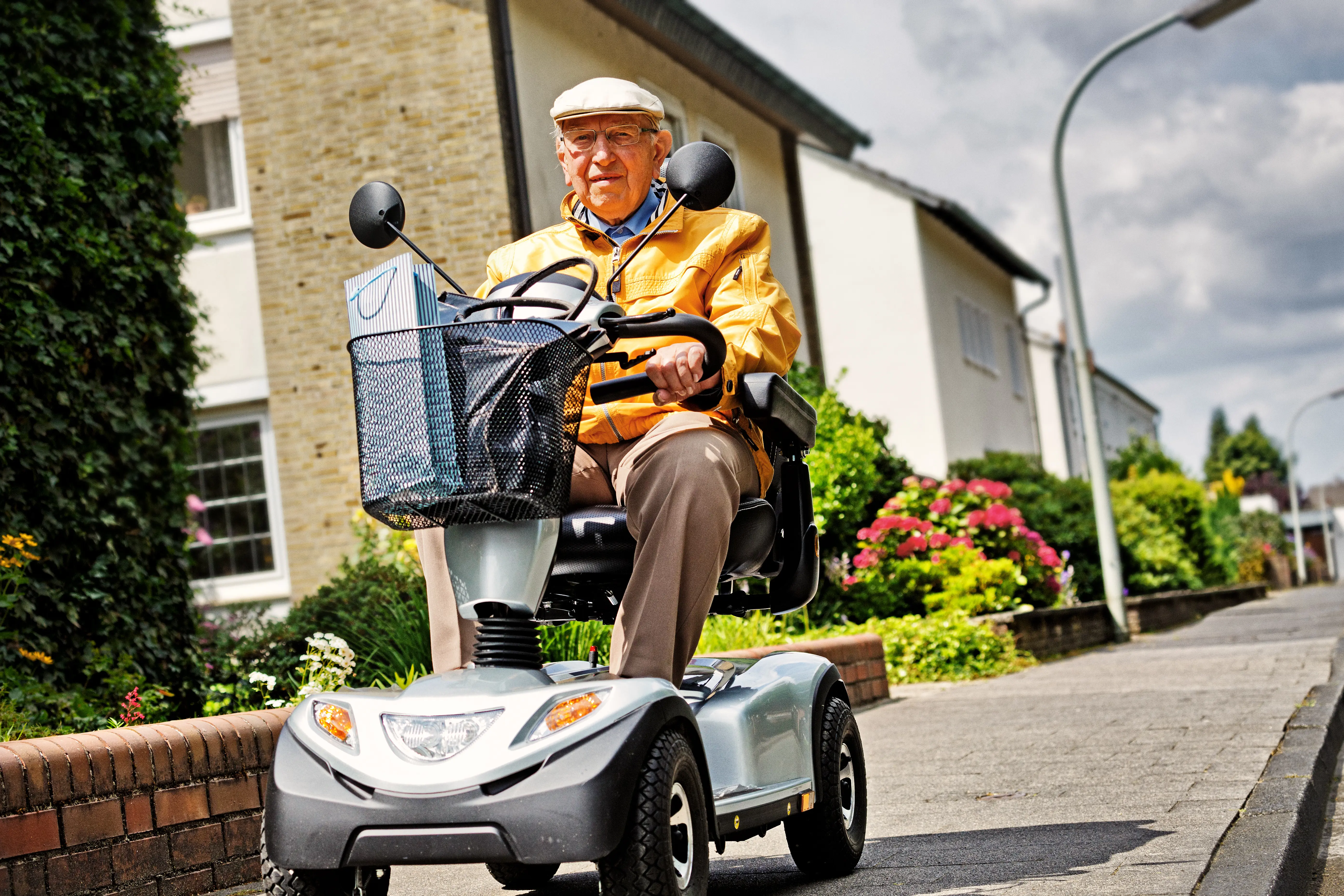 Older Man On Scooter On Pavement