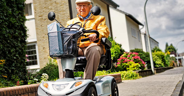 Older Man On Scooter On Pavement