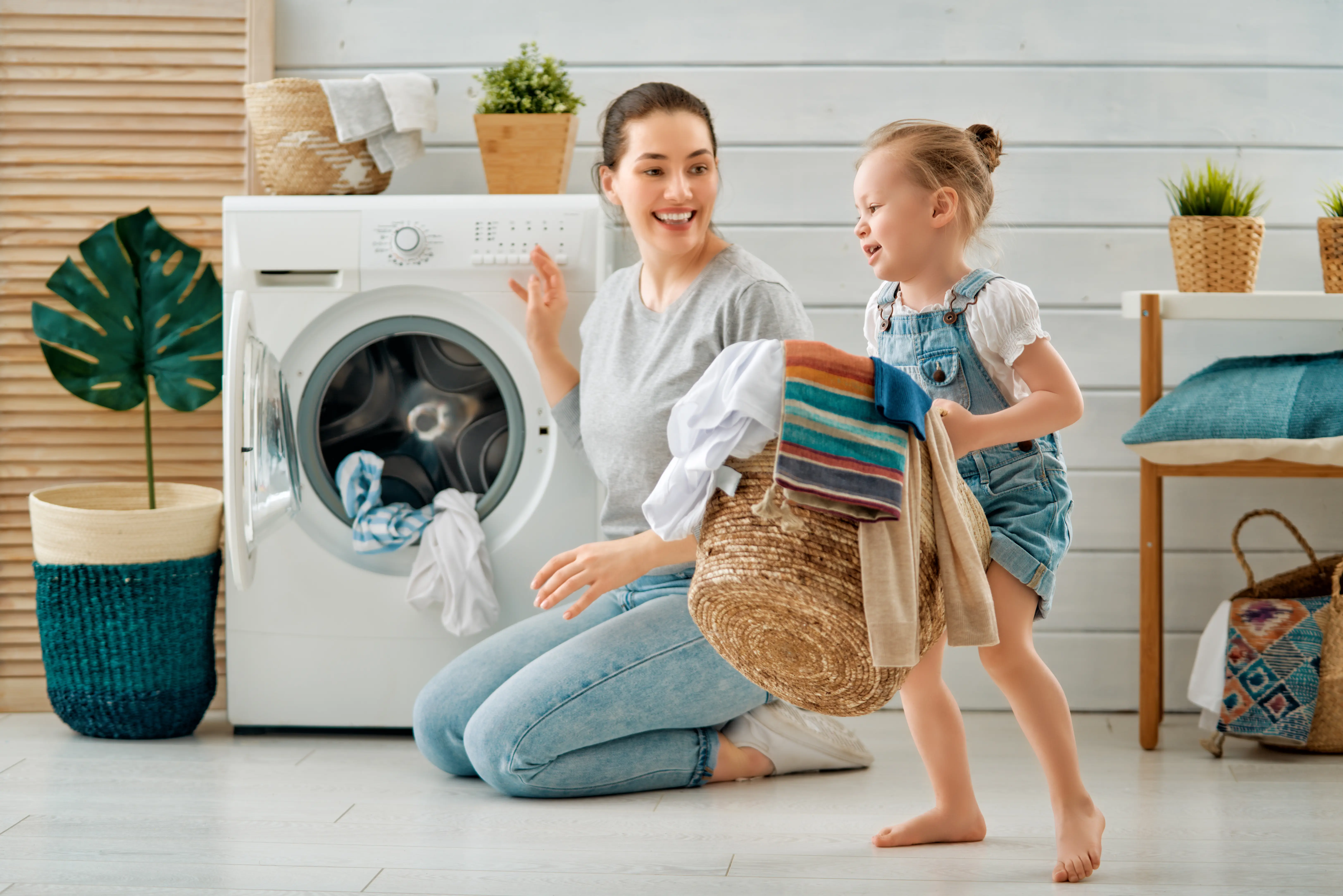 Mum And Child Doing The Washing Together (1)