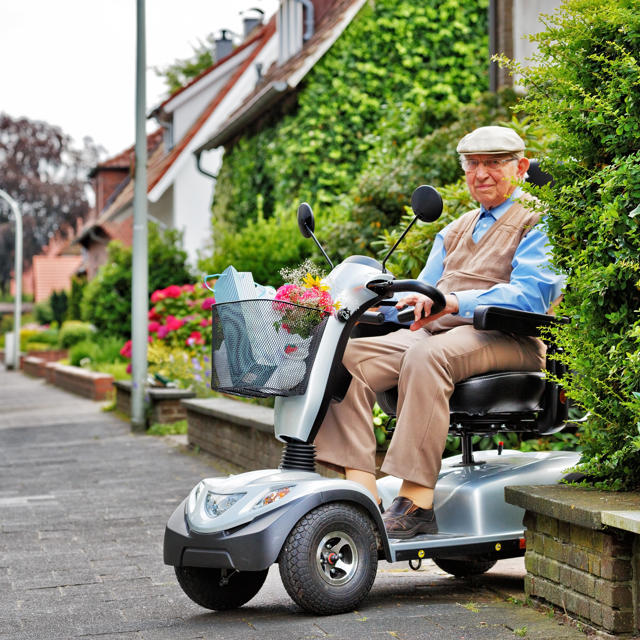 Older Man On Scooter On Pavement 2