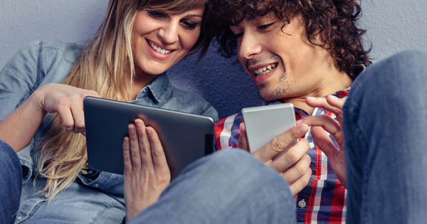 Couple Looking At Tablet