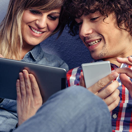 Couple Looking At Tablet