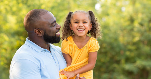 Dad Holding Daughter Outdoors