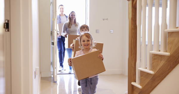 Young Family Moving In Children With Boxes