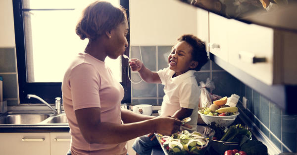 Mother And Young Child Cooking In The Kitchen